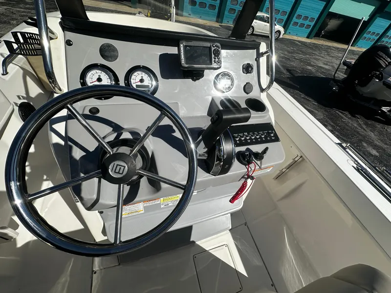 Slide: The Image of 2021 Trophy T20 boat dashboard with steering wheel and gauges. - 4
