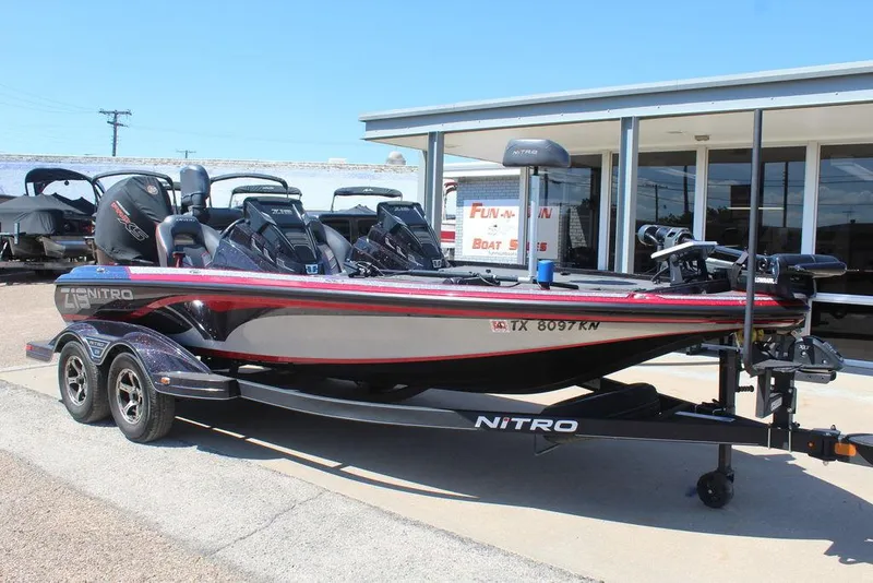 The Image of 2022 Nitro Z19 Pro bass boat on trailer, parked outside dealership. - 1