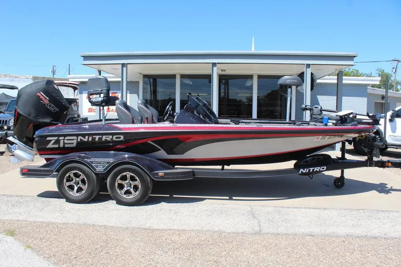 Slide: The Image of 2022 Nitro Z19 Pro boat parked on a trailer outside a building. - 2