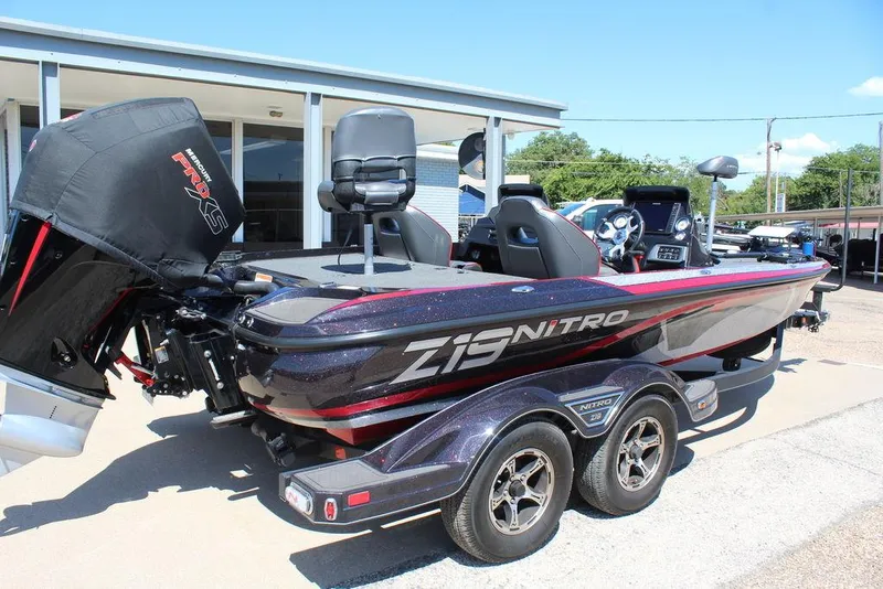 Slide: The Image of 2022 Nitro Z19 Pro boat with dual seats and powerful engine, parked outdoors. - 3