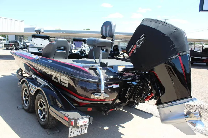 Slide: The Image of 2022 Nitro Z19 Pro boat with dual axle trailer, parked outdoors. - 4