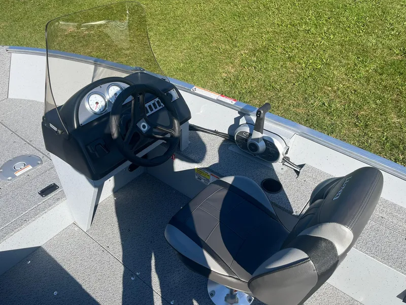 Slide: The Image of 2025 Lund 1600 Fury SS boat interior with steering wheel and seat. - 10