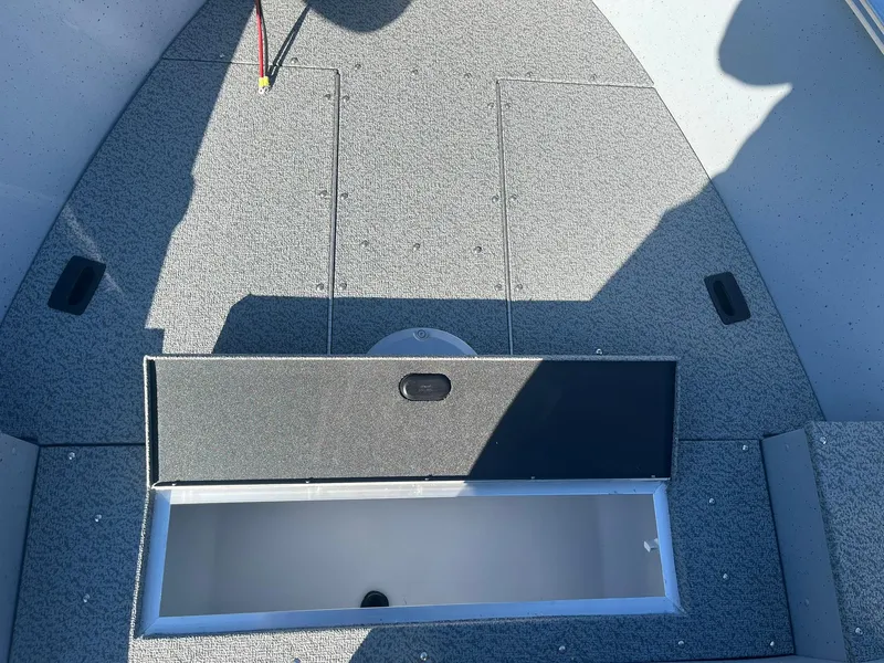 Slide: The Image of 2025 Lund 1600 Fury SS boat interior with open storage compartment. - 14