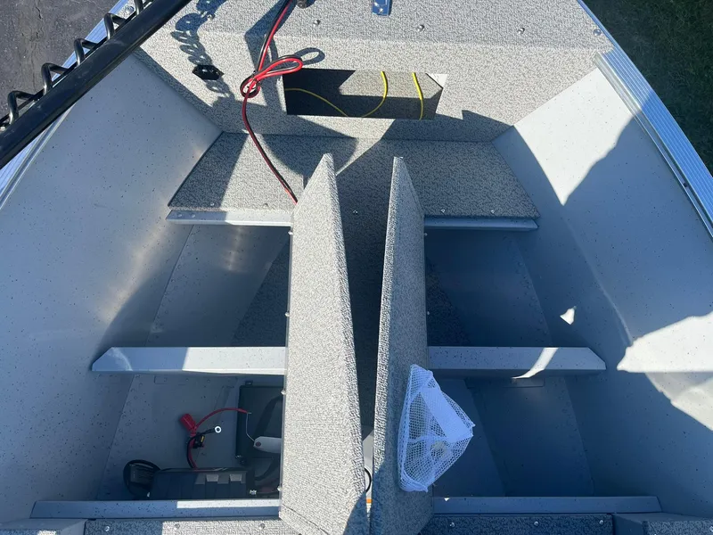 Slide: The Image of 2025 Lund 1600 Fury SS boat interior with storage compartments and wiring. - 15
