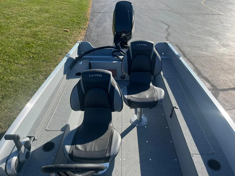 Slide: The Image of 2025 Lund 1600 Fury SS boat interior with two seats and motor. - 16