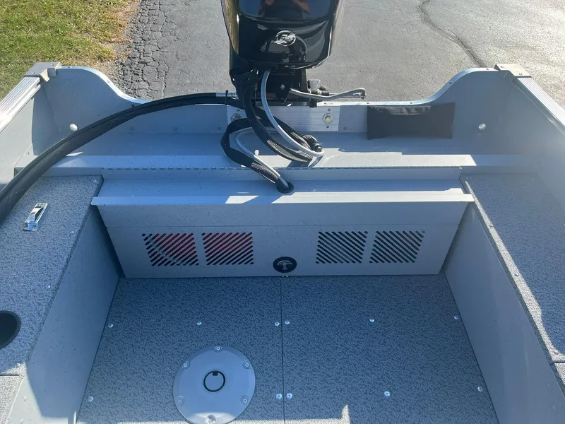 Slide: The Image of 2025 Lund 1600 Fury SS boat interior with motor and storage compartments. - 17