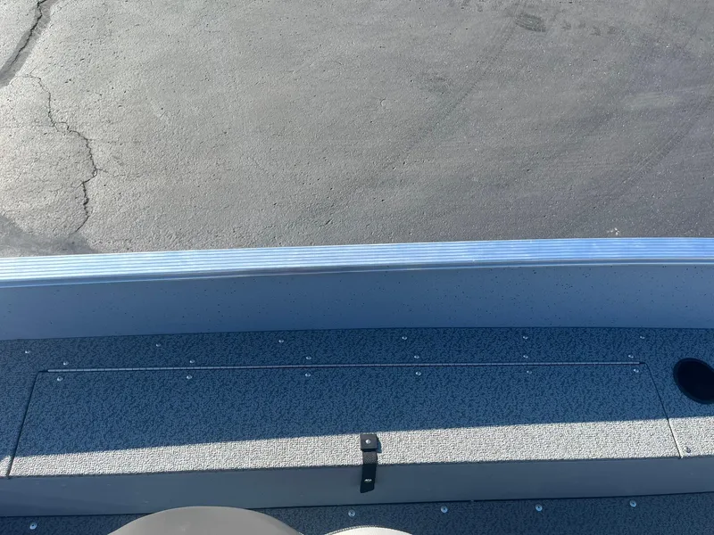 Slide: The Image of 2025 Lund 1600 Fury SS boat interior with storage compartment and textured flooring. - 20