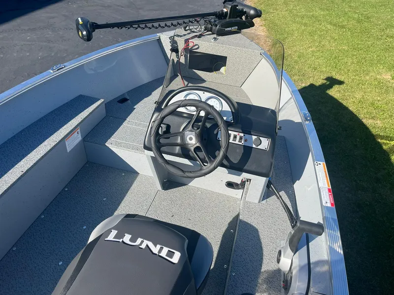Slide: The Image of 2025 Lund 1600 Fury SS boat interior with steering wheel and seating. - 7