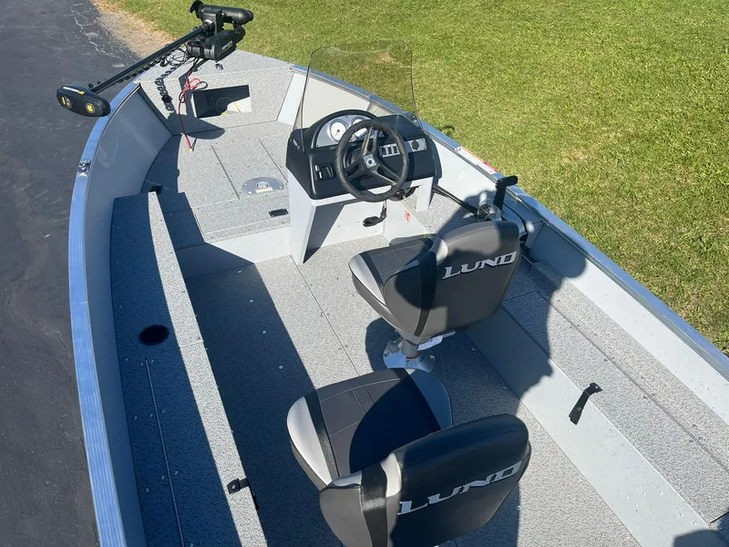 Slide: The Image of 2025 Lund 1600 Fury SS fishing boat interior with steering console and seating. - 8