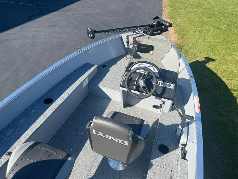 Slide: The Image of 2025 Lund 1600 Fury SS boat interior with steering wheel and seating. - 9