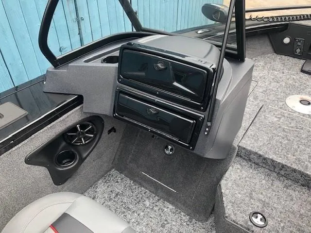 Slide: The Image of 2025 Tracker Targa V18 Combo boat interior with storage compartments and speaker. - 12