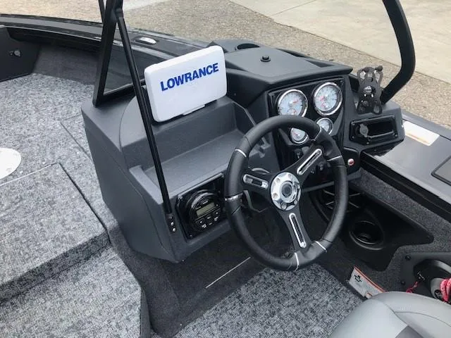 Slide: The Image of 2025 Tracker Targa V18 Combo boat dashboard with Lowrance electronics and steering wheel. - 13
