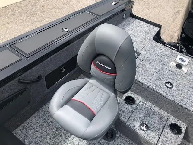 Slide: The Image of 2025 Tracker Targa V18 Combo boat seat with gray upholstery and red accents. - 18