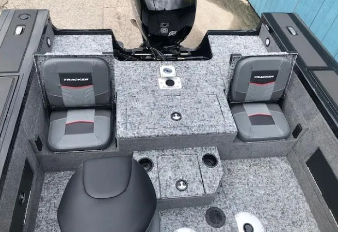 Slide: The Image of 2025 Tracker Targa V18 Combo boat interior with gray seating and storage compartments. - 21