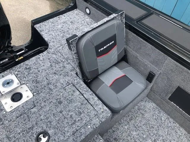 Slide: The Image of 2025 Tracker Targa V18 Combo boat seat with gray upholstery and red accents. - 22