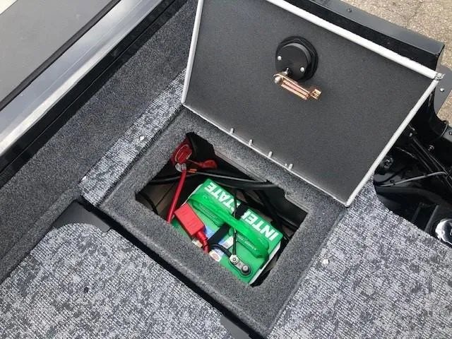 Slide: The Image of 2025 Tracker Targa V18 Combo boat storage compartment with battery. - 25