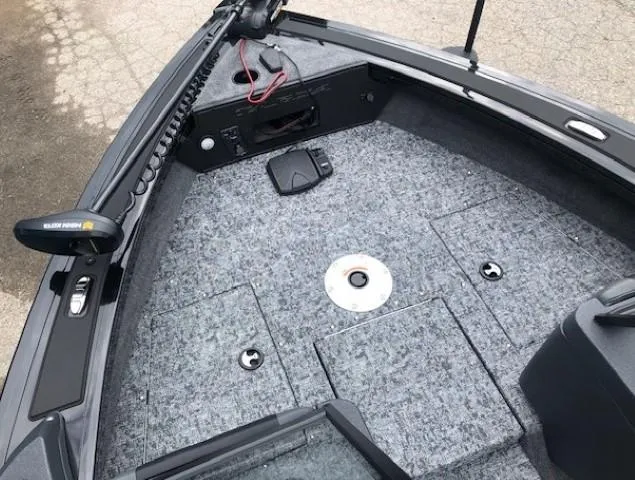 Slide: The Image of 2025 Tracker Targa V18 Combo boat deck with storage compartments and trolling motor. - 6