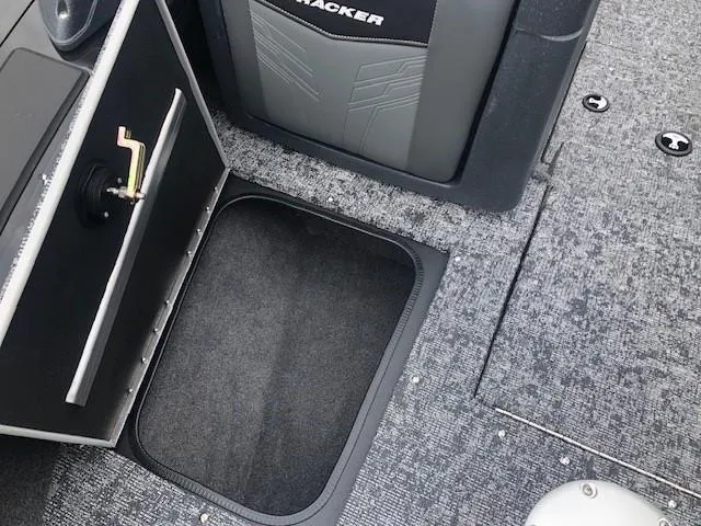 Slide: The Image of 2025 Tracker Targa V18 Combo boat interior with storage compartment and carpeted flooring. - 9