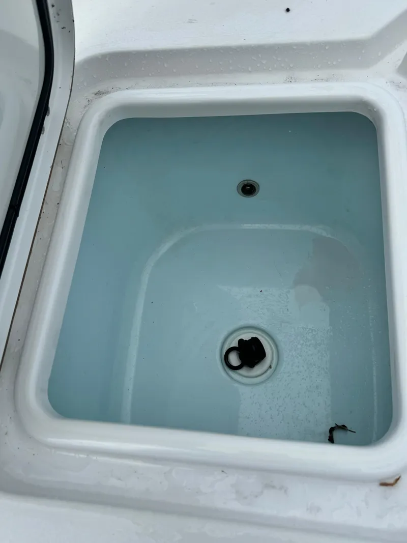 Slide: The Image of Livewell compartment on a 2017 Sportsman Masters 267 Bay Boat, open and empty. - 10