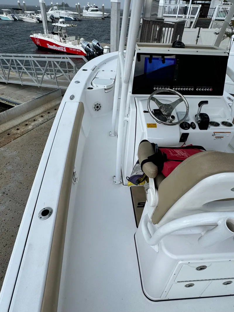 Slide: The Image of 2017 Sportsman Masters 267 Bay Boat docked, featuring helm and seating area. - 17