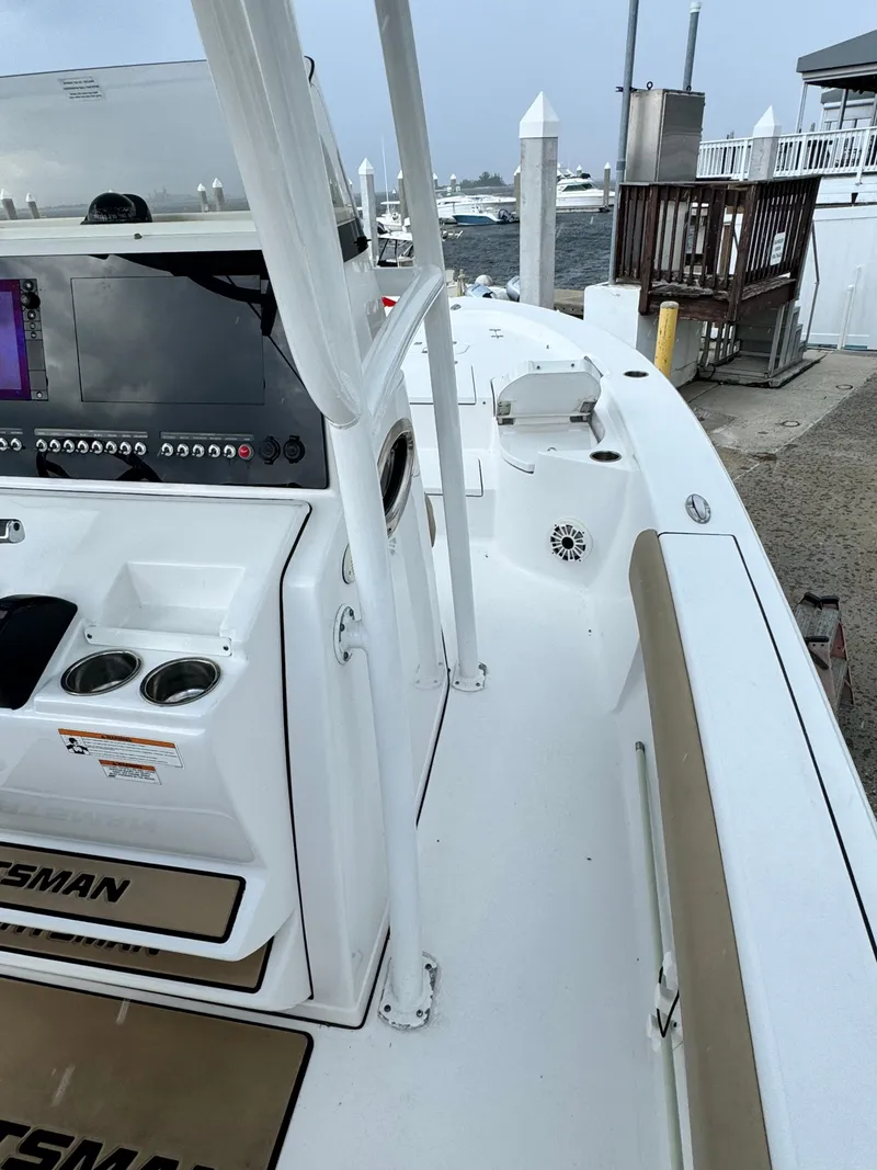 Slide: The Image of 2017 Sportsman Masters 267 Bay Boat docked, featuring sleek design and modern controls. - 18