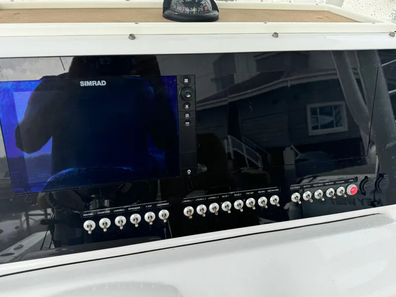 Slide: The Image of Control panel of a 2017 Sportsman Masters 267 Bay Boat with Simrad display. - 21