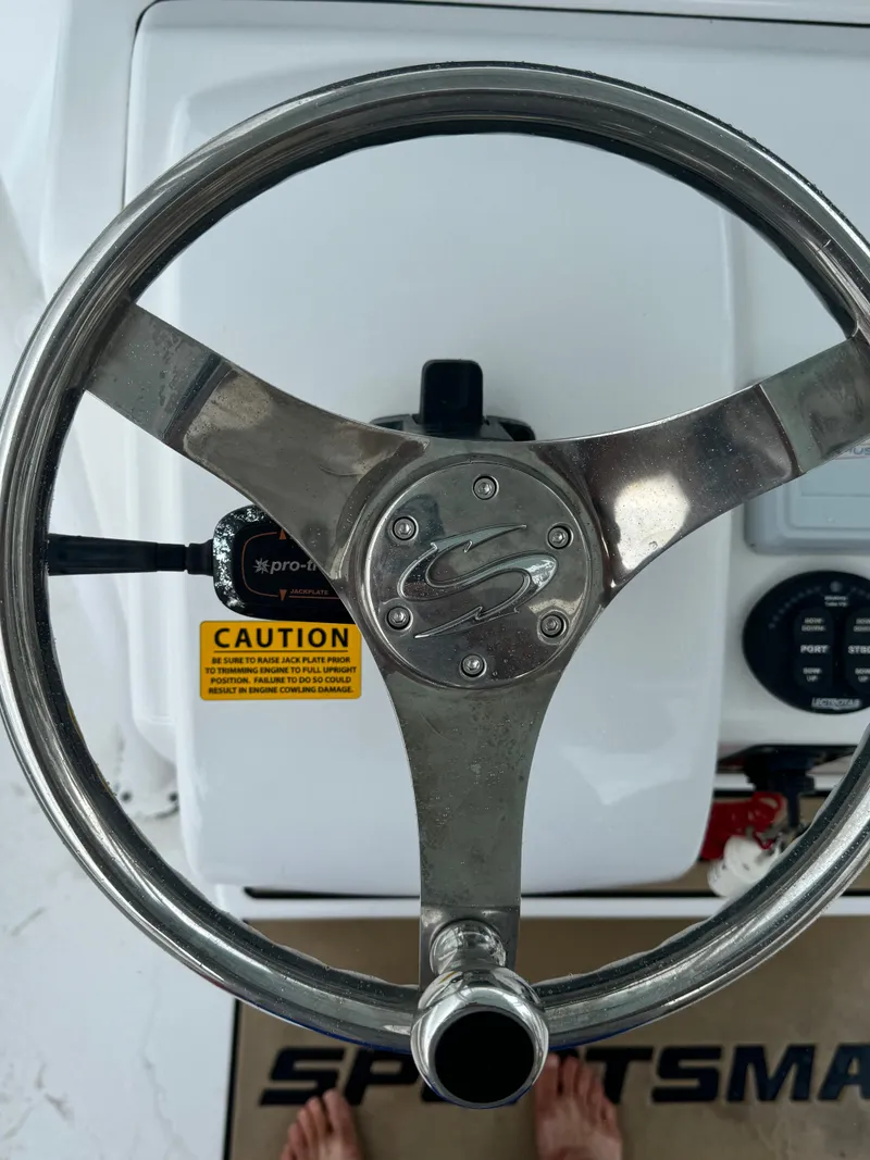 Slide: The Image of Steering wheel of a 2017 Sportsman Masters 267 Bay Boat with caution label. - 24