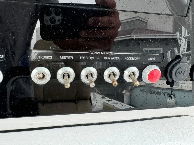 Slide: The Image of Control panel of a 2017 Sportsman Masters 267 Bay Boat with various switches. - 27