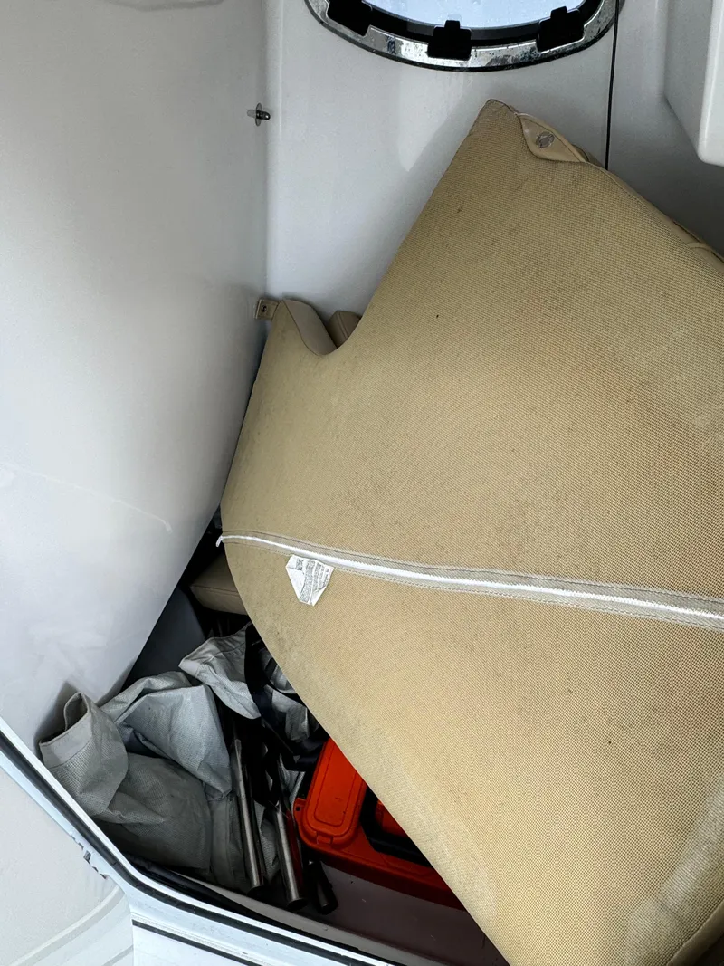 Slide: The Image of Storage compartment in a 2017 Sportsman Masters 267 Bay Boat with cushions and equipment. - 32