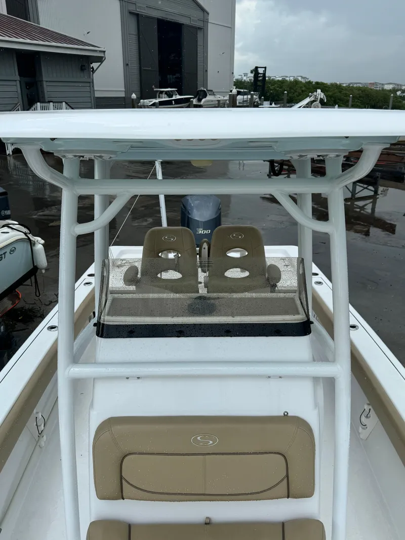 Slide: The Image of 2017 Sportsman Masters 267 Bay Boat with dual seats and T-top in a marina setting. - 33