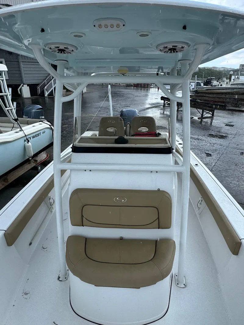 Slide: The Image of 2017 Sportsman Masters 267 Bay Boat with seating and T-top, docked in a marina. - 34