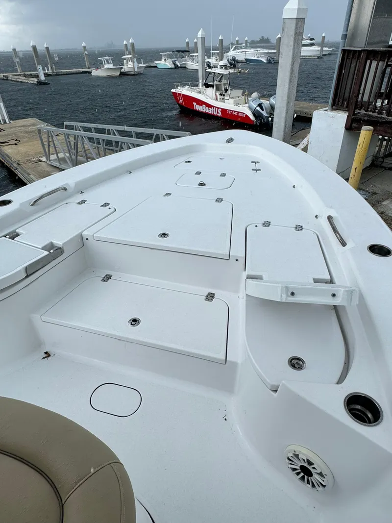 Slide: The Image of 2017 Sportsman Masters 267 Bay Boat docked, showcasing spacious deck and storage compartments. - 36