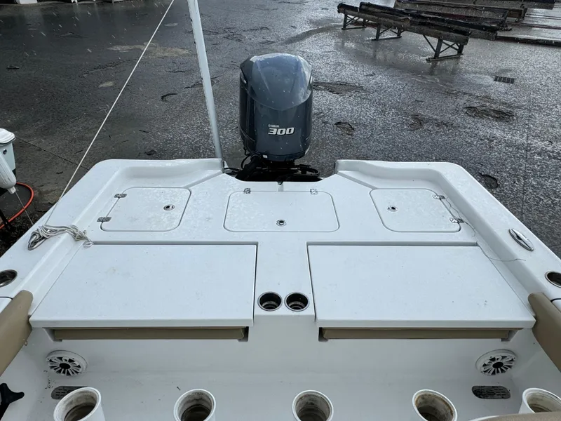 Slide: The Image of 2017 Sportsman Masters 267 Bay Boat with 300 HP engine, docked on wet pavement. - 7