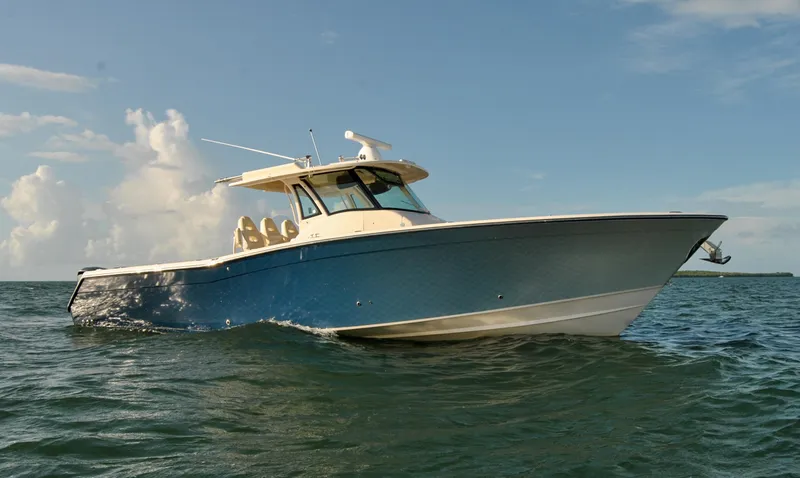 The Image of 2018 Grady-White Canyon 376 boat cruising on open water under a clear sky. - 0