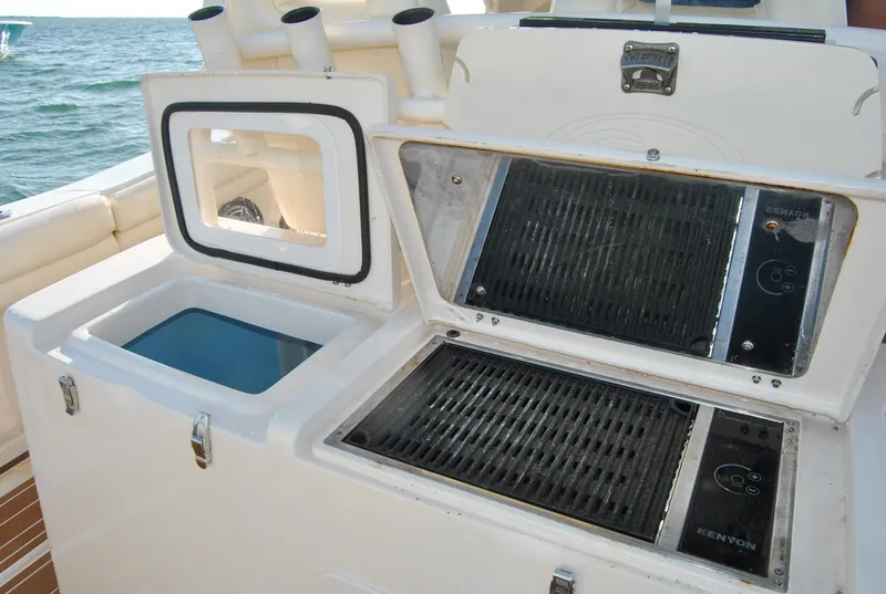 Slide: The Image of 2018 Grady-White Canyon 376 boat with grill and storage compartments on deck. - 11