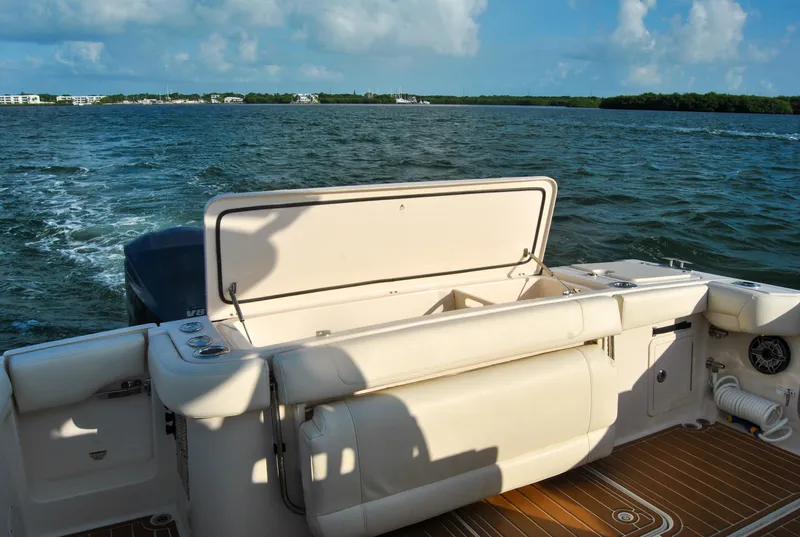 Slide: The Image of 2018 Grady-White Canyon 376 boat on water, featuring spacious deck and seating. - 14
