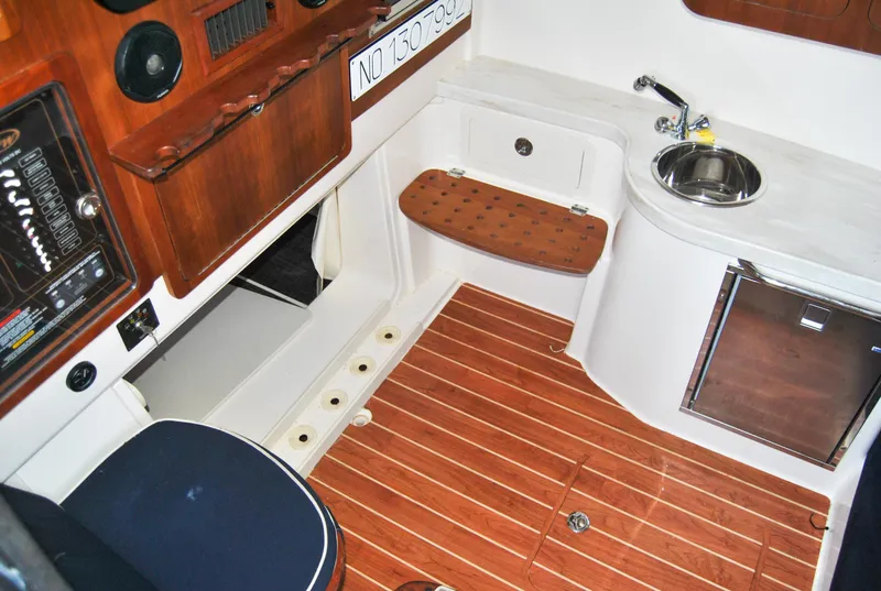 Slide: The Image of 2018 Grady-White Canyon 376 interior with wood accents, sink, and seating. - 19