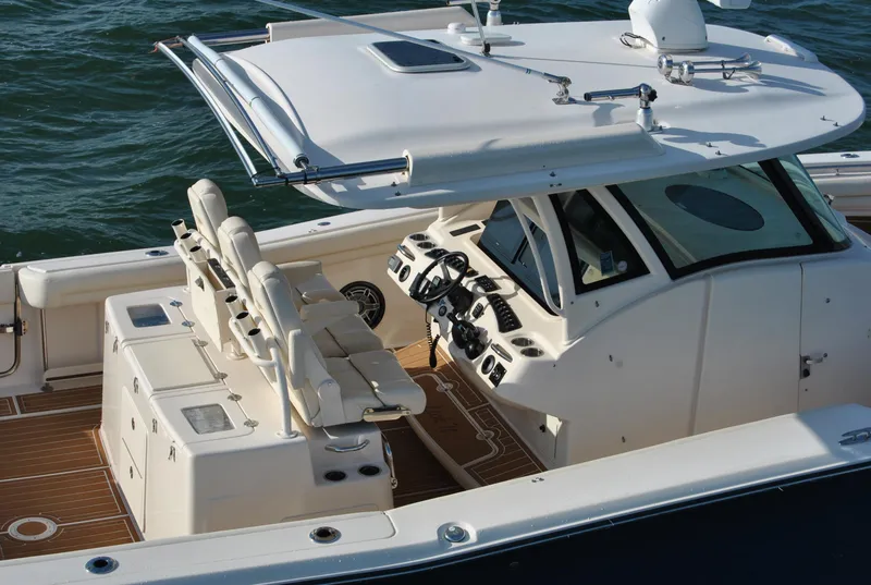 Slide: The Image of 2018 Grady-White Canyon 376 boat with spacious deck and modern helm, cruising on water. - 2