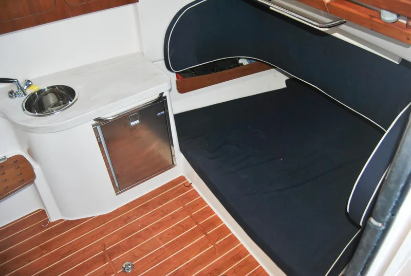 Slide: The Image of 2018 Grady-White Canyon 376 cabin interior with sink, mini-fridge, and cushioned seating. - 20