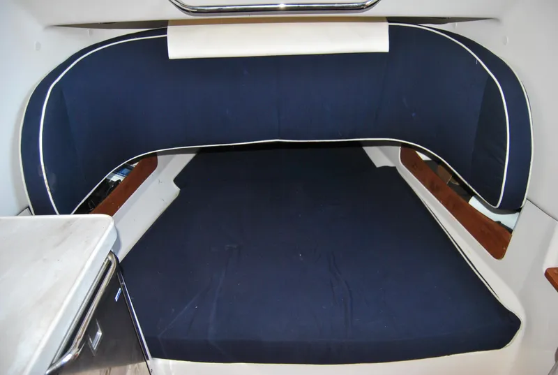 Slide: The Image of 2018 Grady-White Canyon 376 cabin interior with blue cushioned seating. - 21