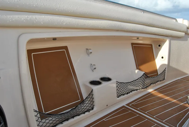 Slide: The Image of 2018 Grady-White Canyon 376 boat storage compartment with netting and cup holders. - 23