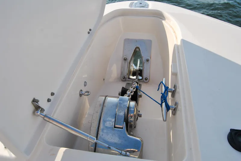 Slide: The Image of Anchor compartment of 2018 Grady-White Canyon 376 boat, featuring winch and chain. - 27