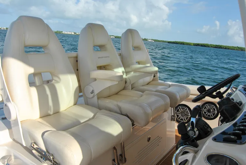 Slide: The Image of 2018 Grady-White Canyon 376 boat with luxurious seating, cruising on a sunny day. - 3