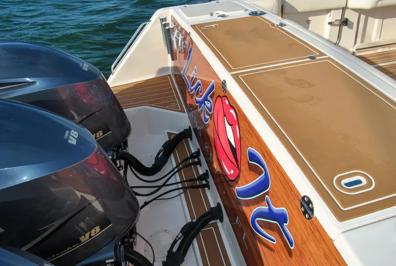 Slide: The Image of 2018 Grady-White Canyon 376 boat with twin V8 engines, custom graphics, and teak deck. - 30