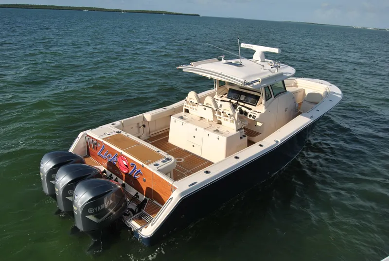 Slide: The Image of 2018 Grady-White Canyon 376 boat with triple Yamaha engines on open water. - 33