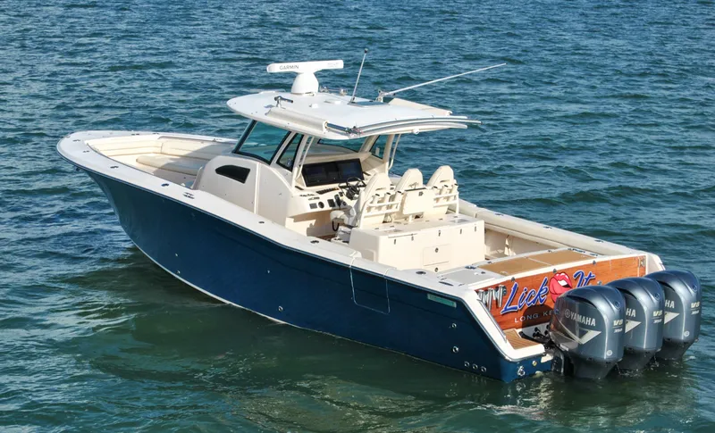Slide: The Image of 2018 Grady-White Canyon 376 boat with triple Yamaha engines on the water. - 34