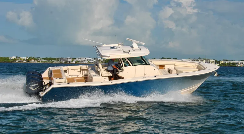 Slide: The Image of 2018 Grady-White Canyon 376 boat cruising on open water under a cloudy sky. - 39