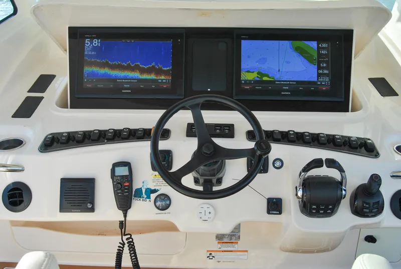 Slide: The Image of Helm of 2018 Grady-White Canyon 376 with dual navigation screens and controls. - 4