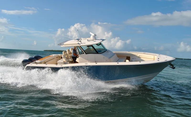 Slide: The Image of 2018 Grady-White Canyon 376 boat cruising on open water under a clear blue sky. - 40