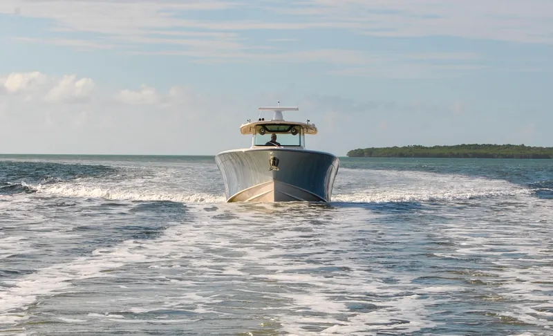 Slide: The Image of 2018 Grady-White Canyon 376 boat cruising on open water. - 43